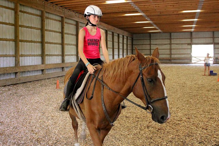 A camper in our indoor horse riding arena