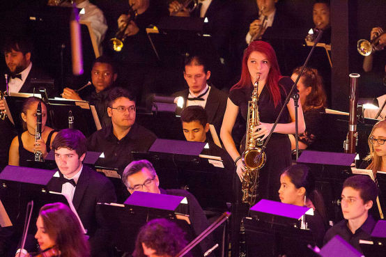 A camper performs a Saxaphone solo during a symphony concert