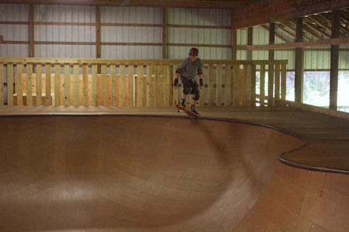 A camper drops into the bowl inside our indoor skating arena